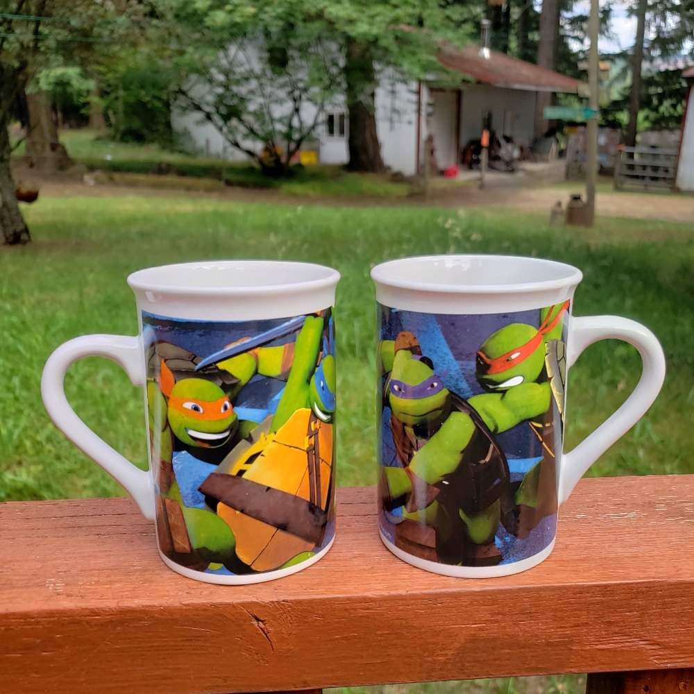(2) 2014 Teenage Mutant Ninja Turtles Coffee Mugs WITH SMALL IMPERFECTIONS